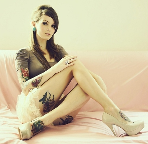 Девушка с татуировками на руках и ногах